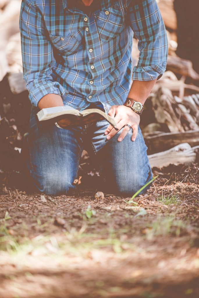 man-kneeling-reading-bible